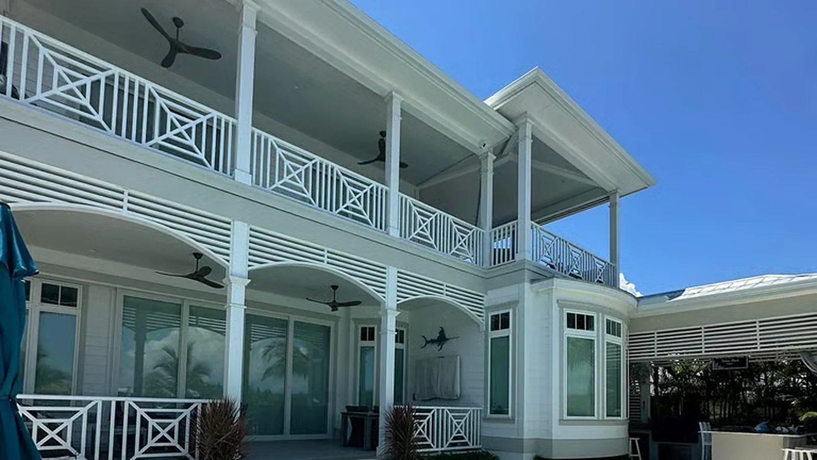 White coastal home with covered balconies and crisp white trim on the Suncoast